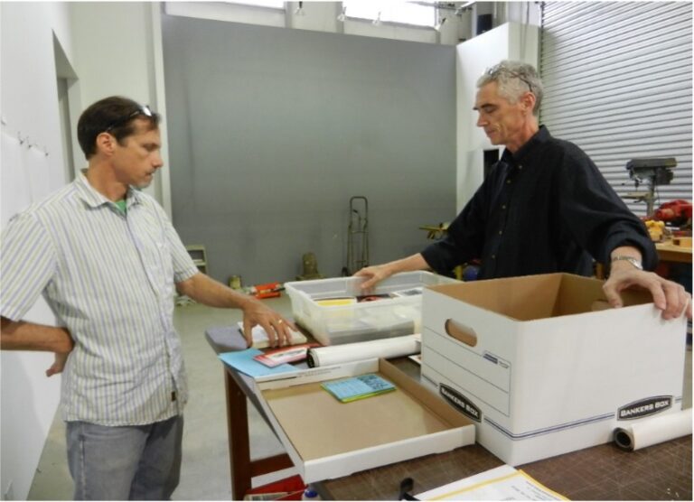 Art Guys Jack Massing (left) and the late Michael Galbreth (right) look over their archival records.